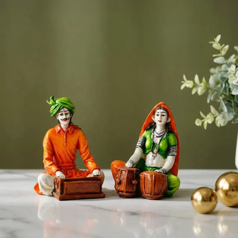 Pair of colourful folk musician figurines displayed on a tabletop