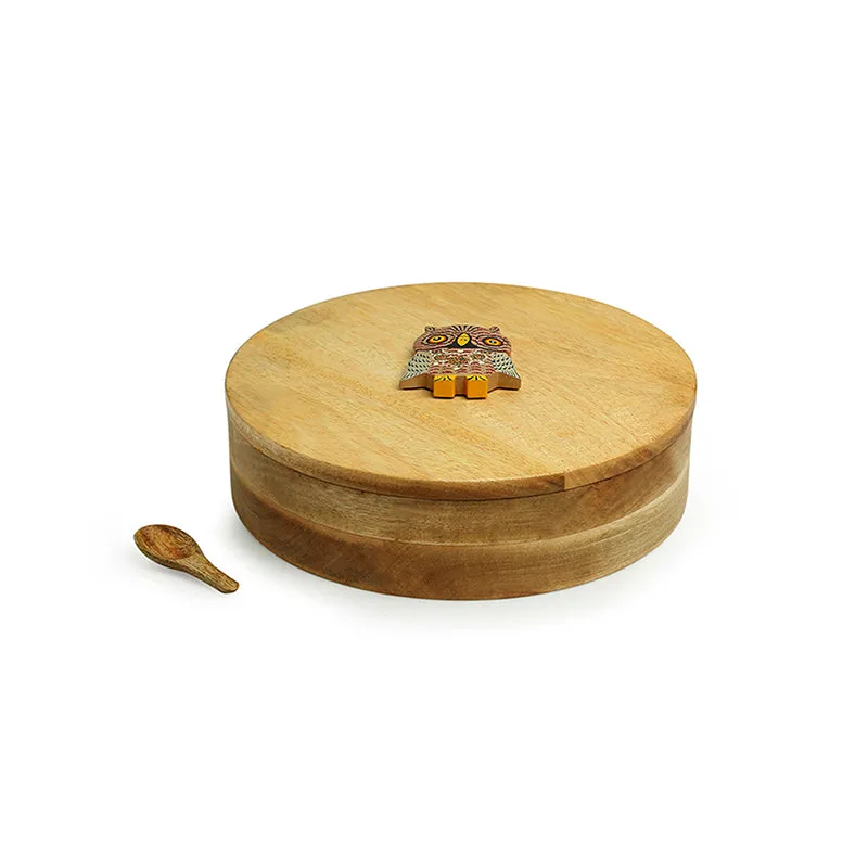 Closed round brown wooden masala box with an owl detail on the lid