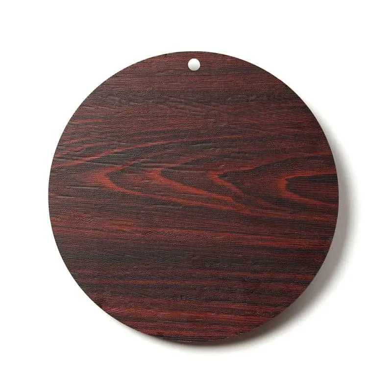 Close-up of the round brown wood-look wall accent showing its textured surface