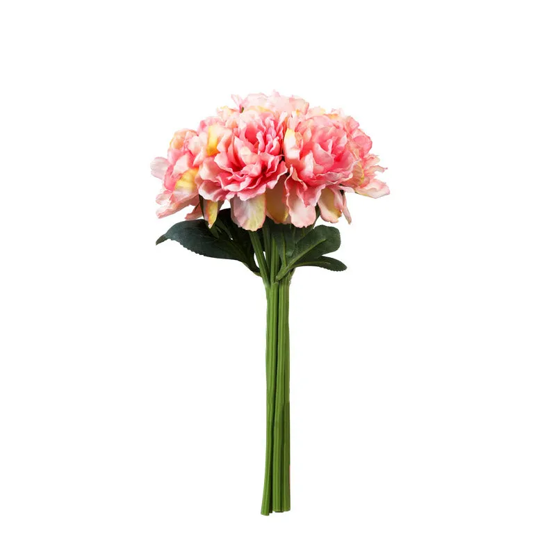 Single pink artificial peony flower with green leaves on a white background