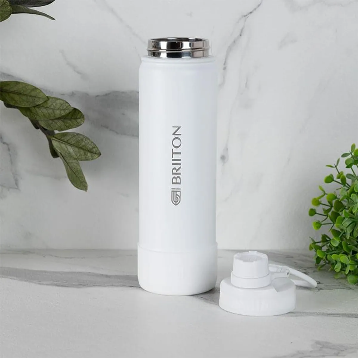 White insulated bottle with its alternate lid placed beside it