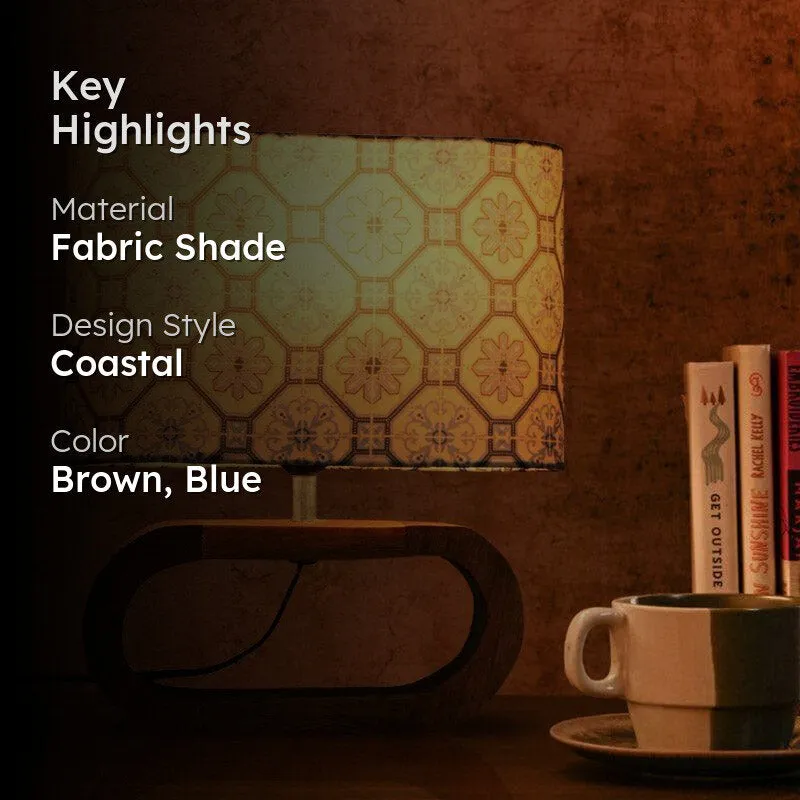 Lit blue patterned table lamp with text overlay on a dark background