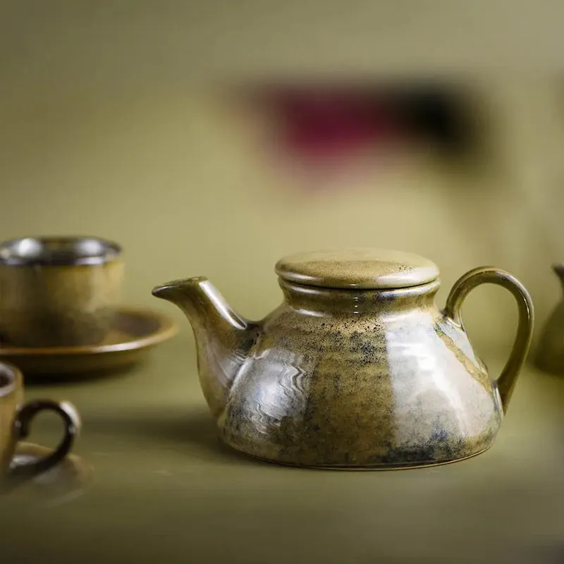 Green ceramic teapot with lid and glossy speckled glaze