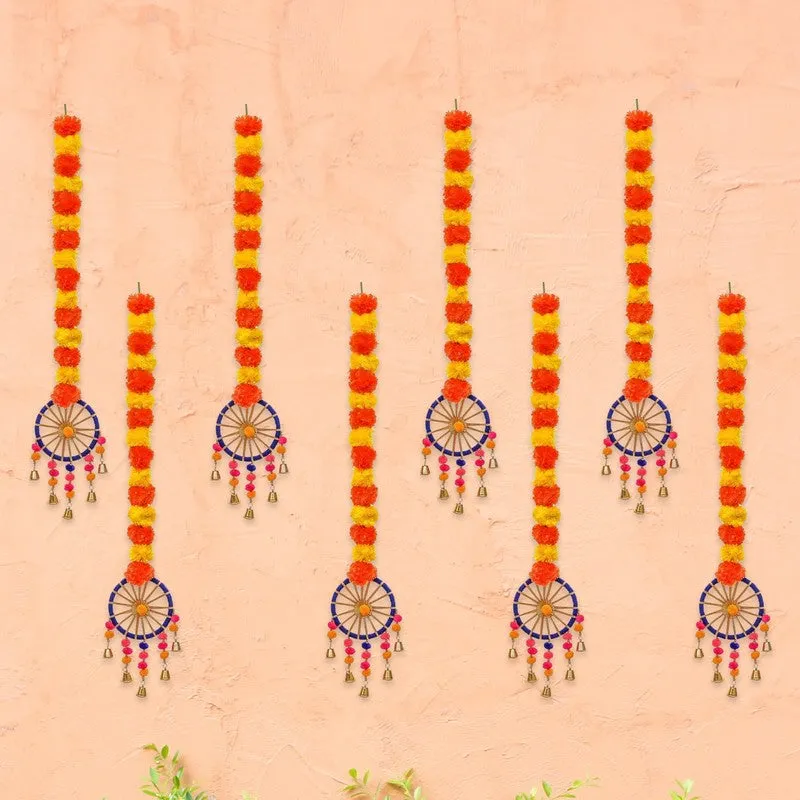 Set of multicolour marigold latkans arranged on a peach wall