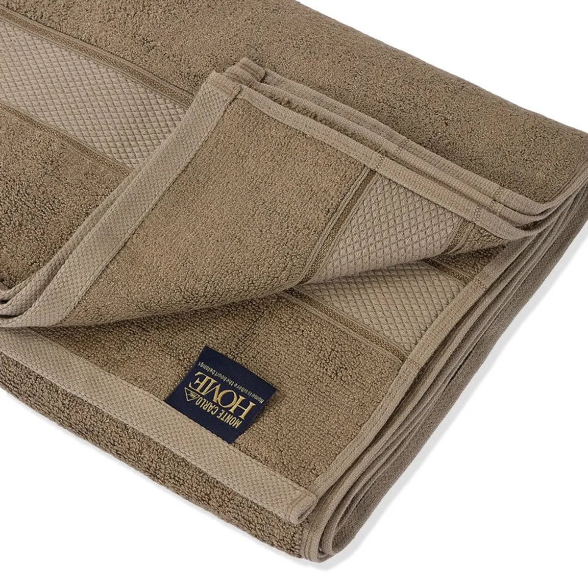 Close-up of the brown towel showing its plush texture and folded edge.