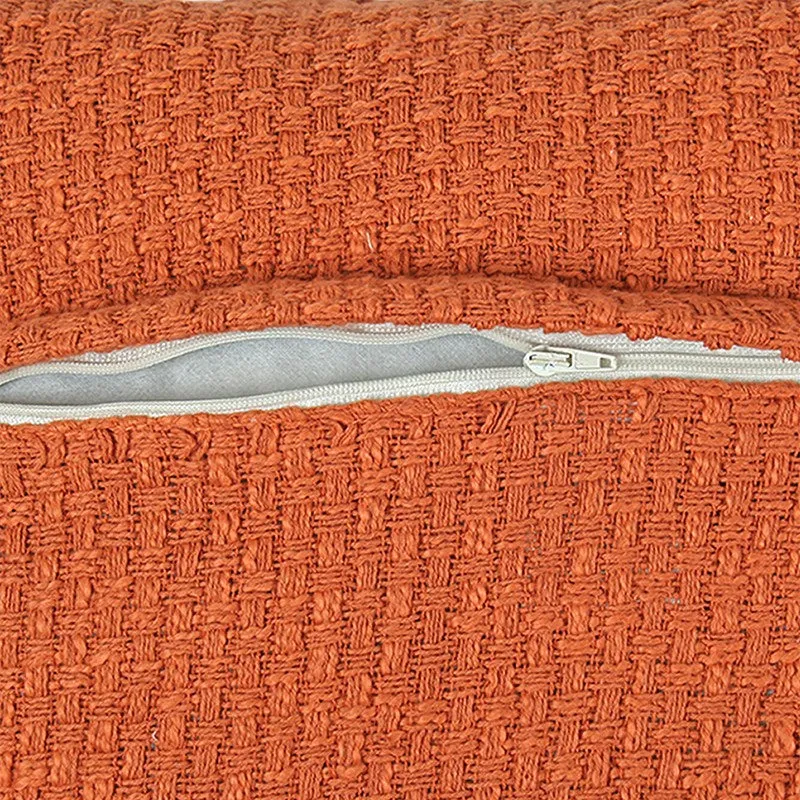 Close-up of the orange cushion cover with zip opening