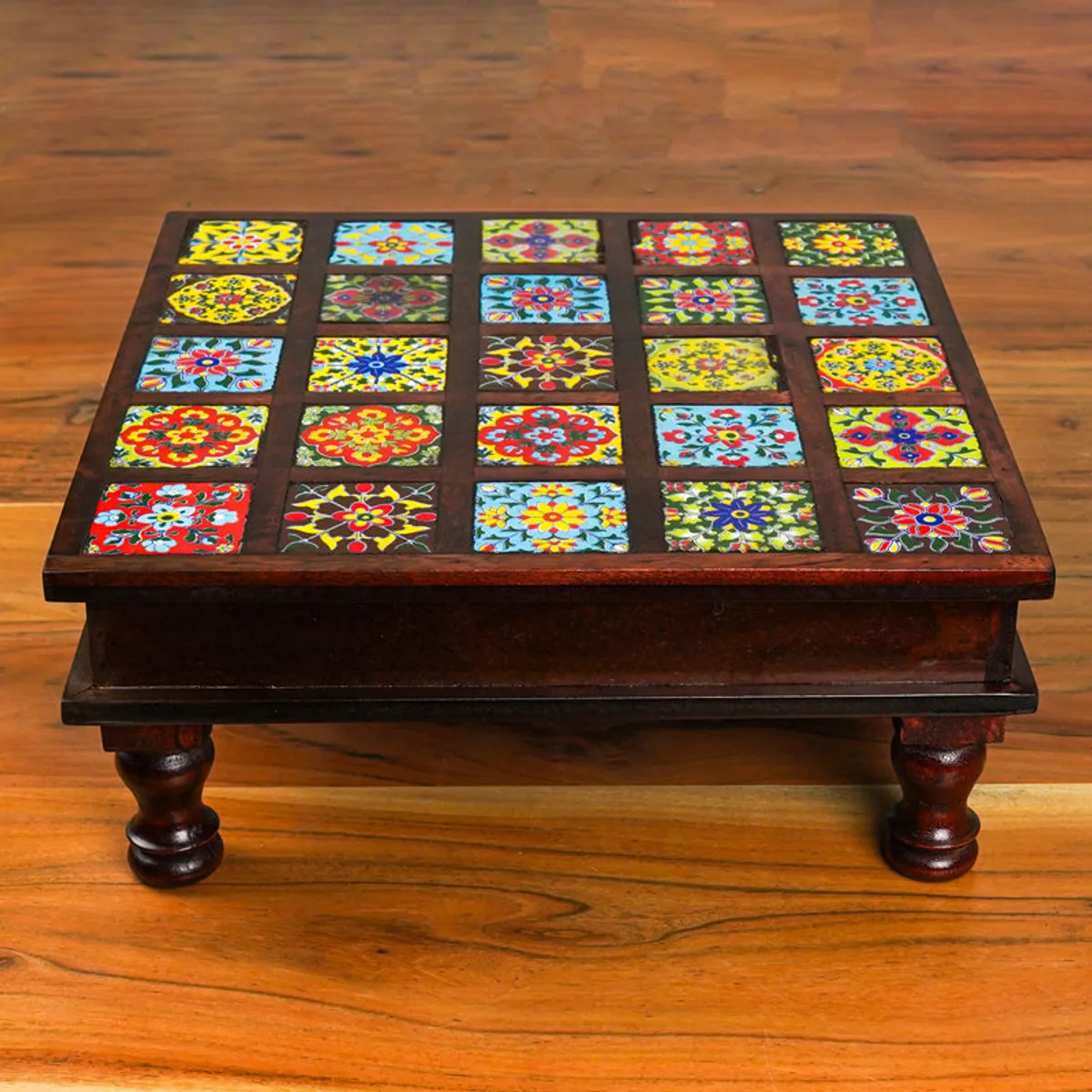 Front view of a square multicolour tiled stool with dark wood frame and turned legs