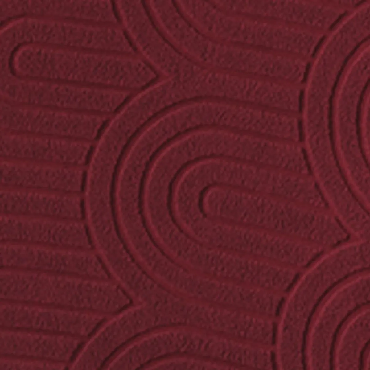 Close-up view of the chair cover's raised curved abstract texture in maroon