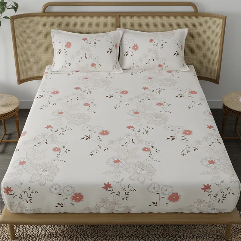 Front view of floral peach and white bedsheet spread on a double bed