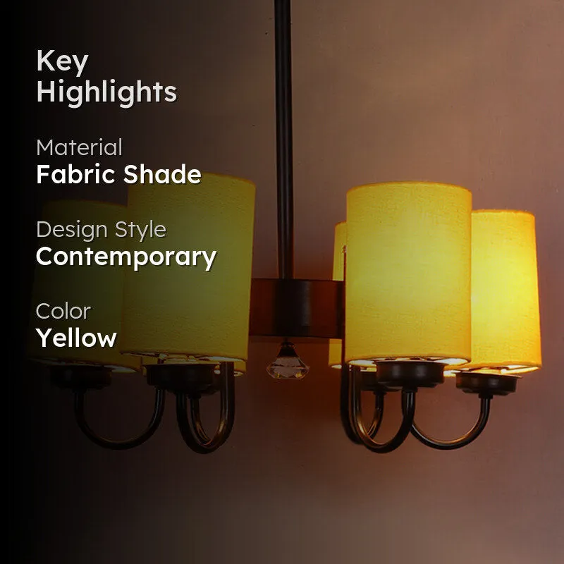 Yellow ceiling lamp with glowing shades against a darkened background