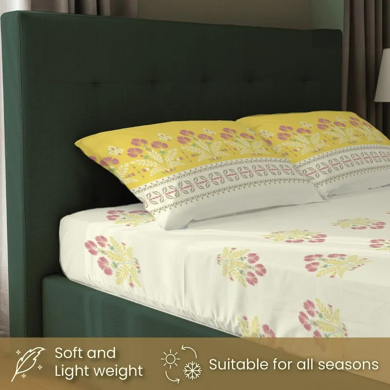 Close-up of pillow covers and fitted bedsheet in yellow floral print