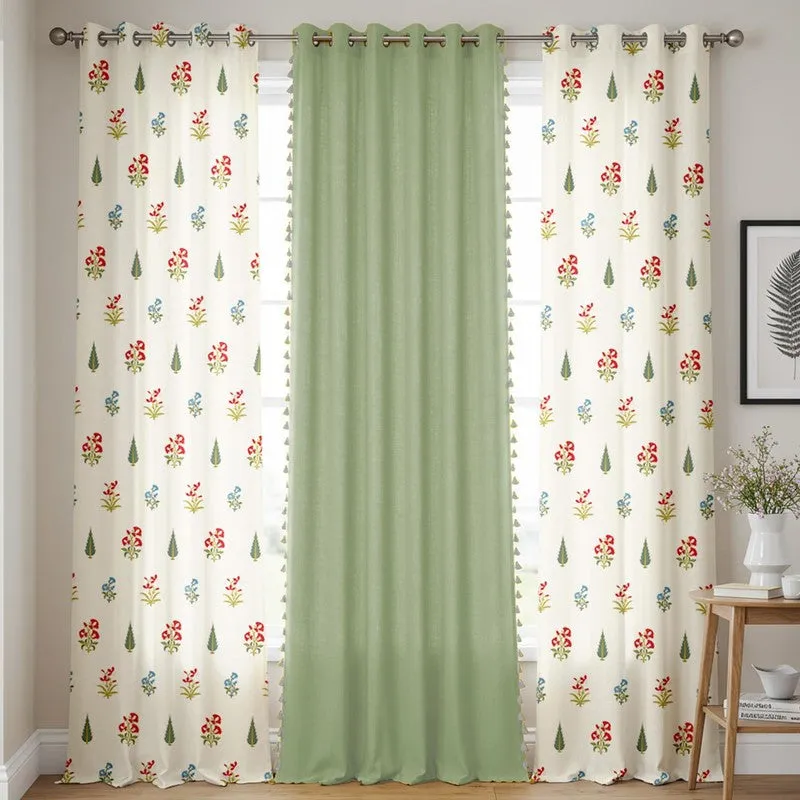 Green and white floral curtains styled across a bright window