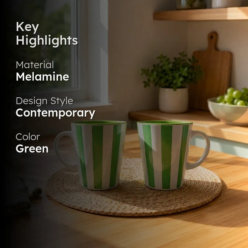 Two green and white striped coffee mugs displayed in a dining setting