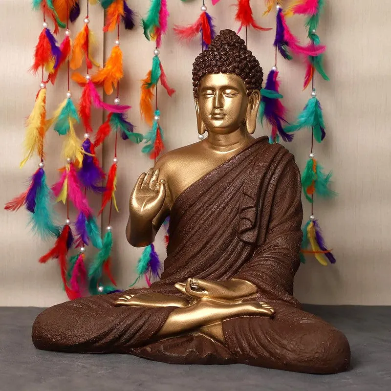 Side angled view of seated Buddha idol in brown and gold