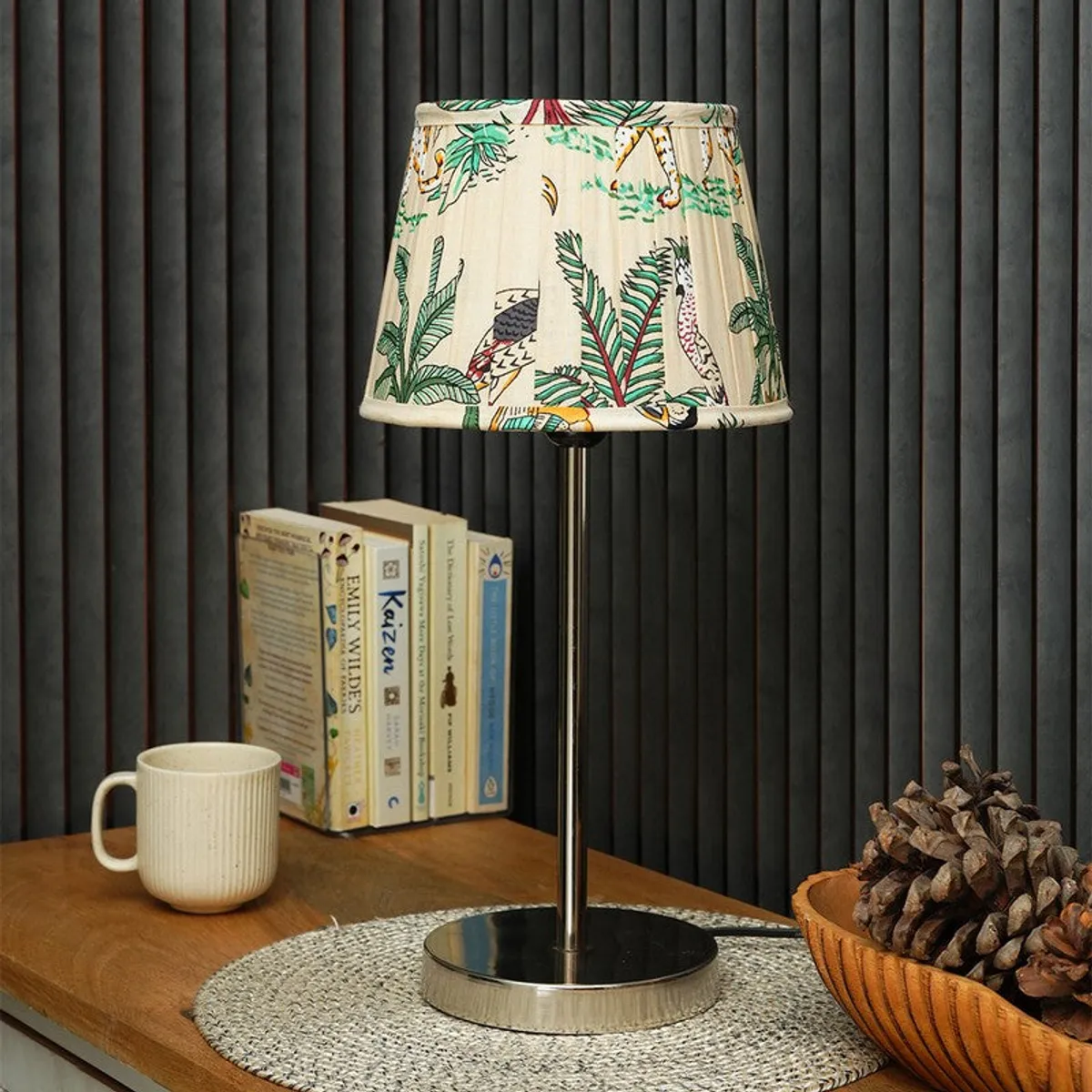 Close view of off-white tropical patterned lamp shade and reflective metal base