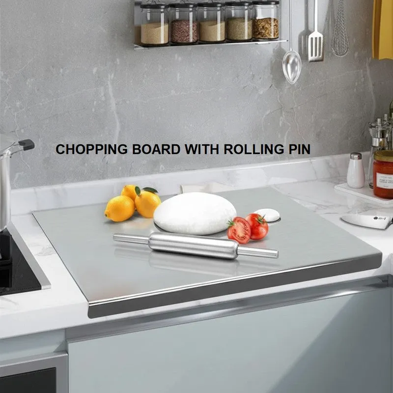 Steel board with rolling pin and dough on a kitchen counter