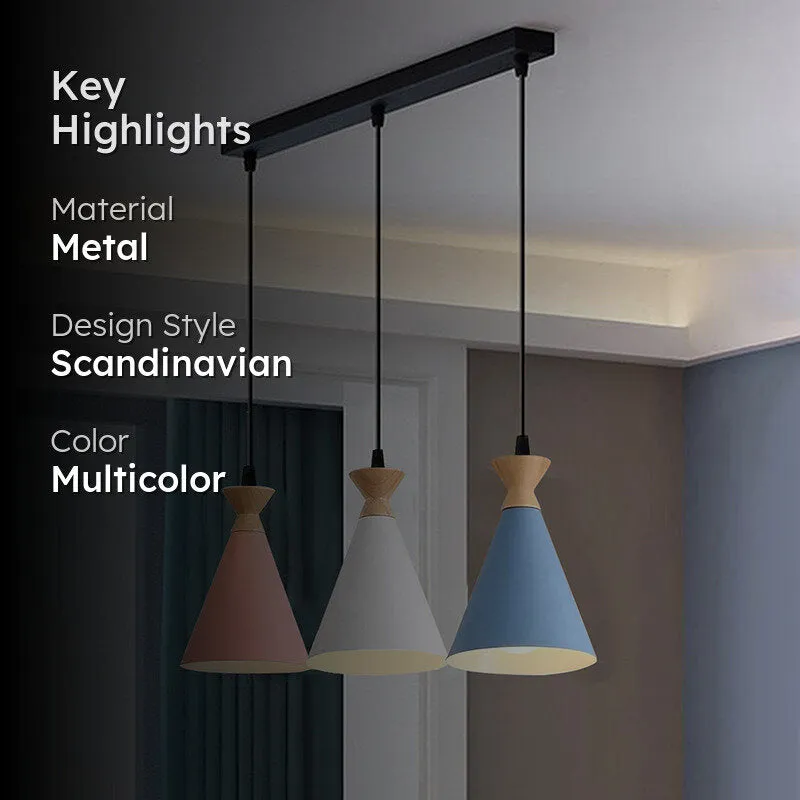 Three pastel conical pendant shades hanging from a black ceiling bar in a styled interior.