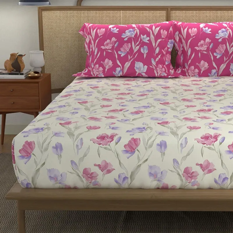Close view of cream floral bedsheet with pink and lilac flowers