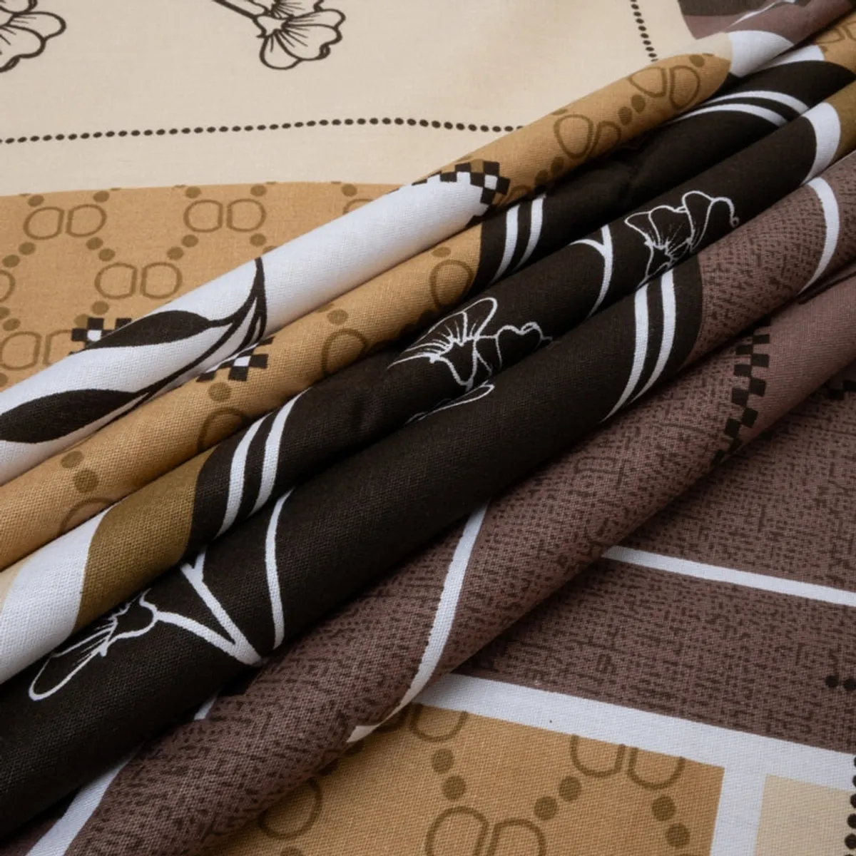Folded printed cotton bedsheet showing geometric stripes and floral motifs