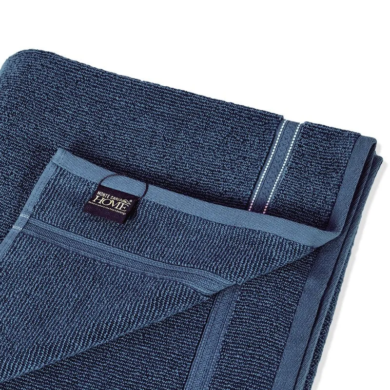 Close-up of blue bath towel corner and hanging loop