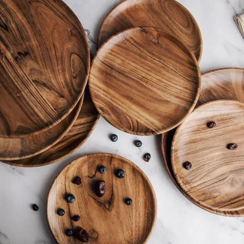 Close-up arrangement of round brown wooden plates with visible natural grain