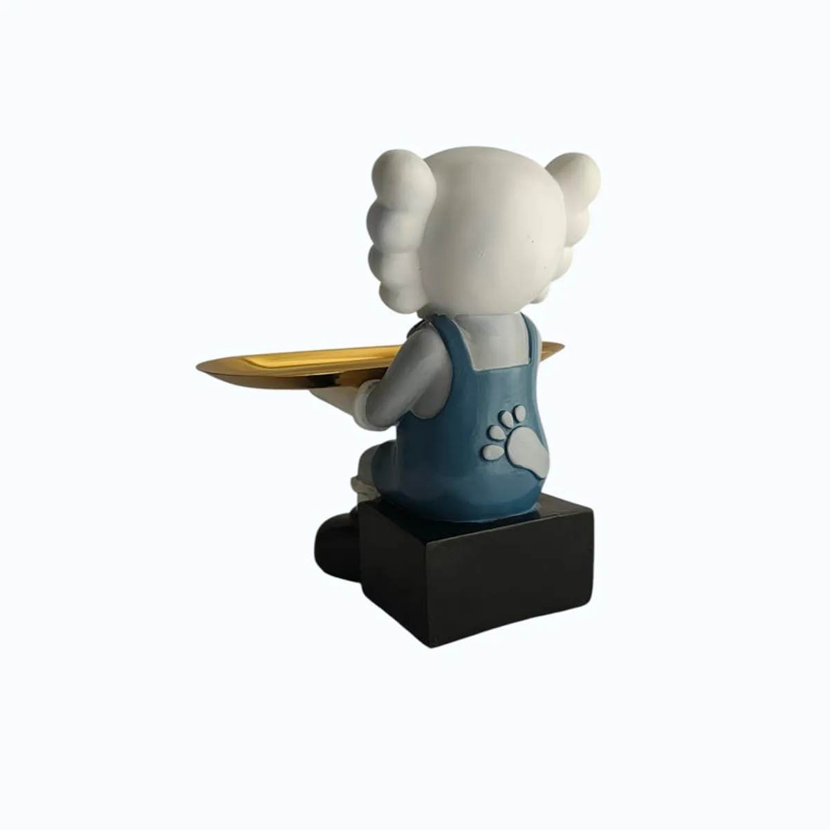 Side view of the cartoon figurine holding a gold tray