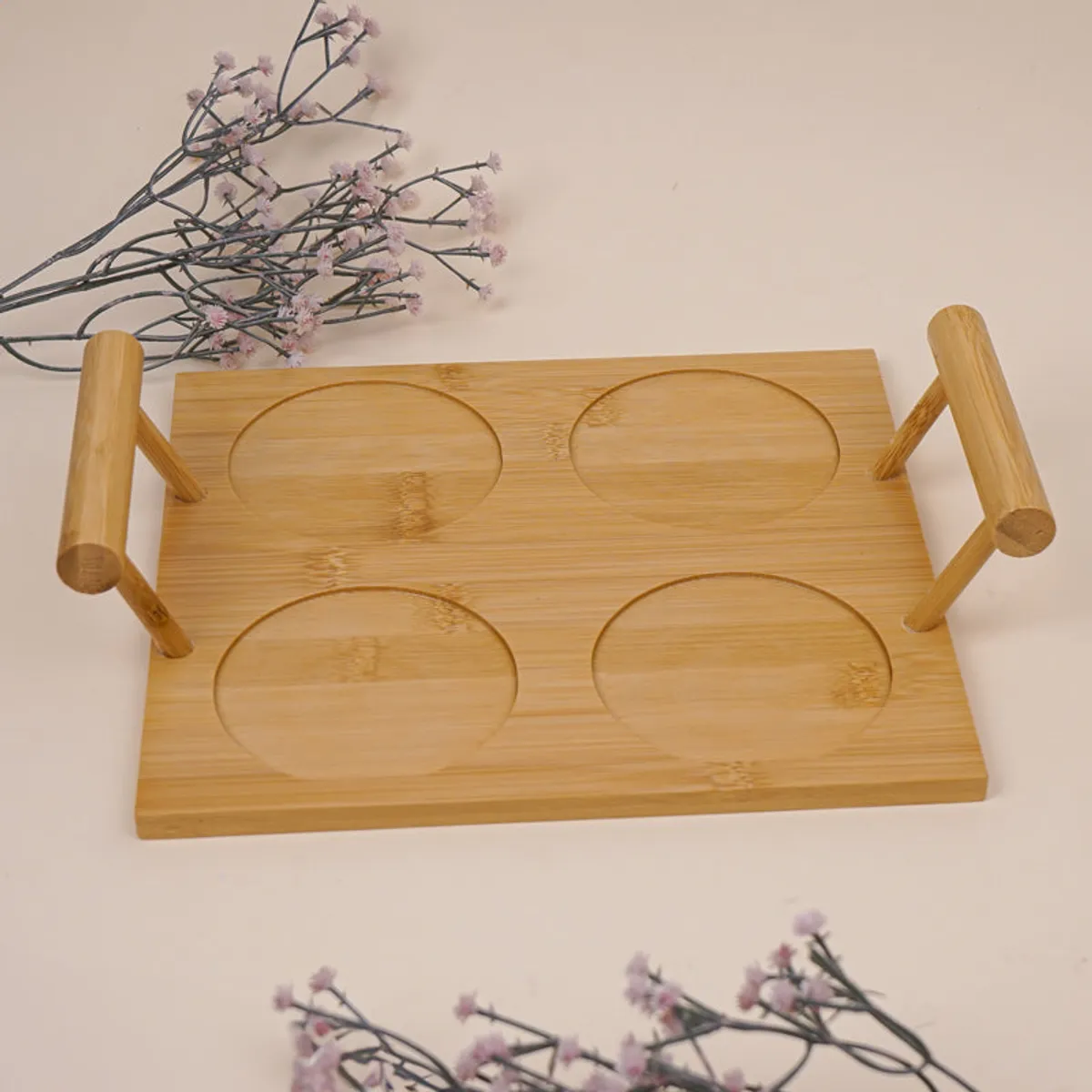Empty bamboo tray with four circular jar spaces and raised handles