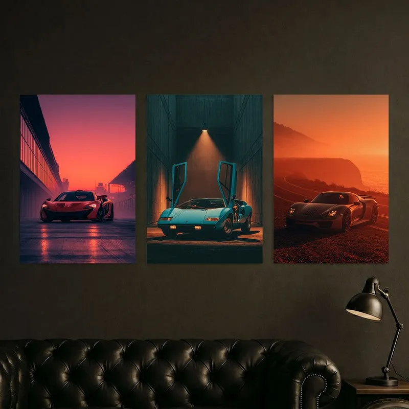 Three automotive posters hung above a dark leather sofa