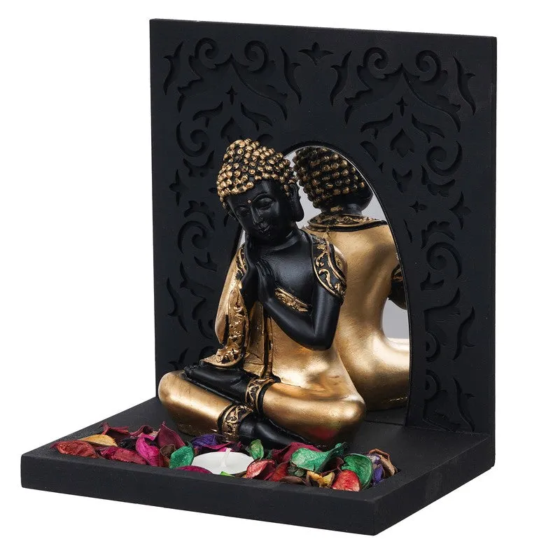 Angled view of Buddha tea light holder with black frame and gold figure