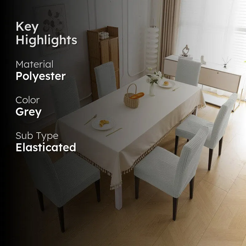 Grey elasticated chair covers styled in a bright dining room