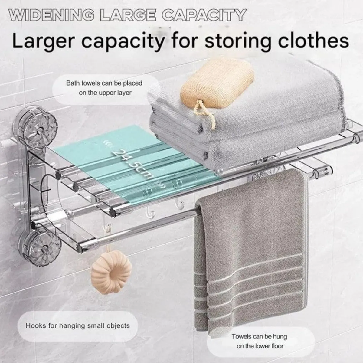 Silver wall-mounted hanger with folded towels on top and towel hanging below