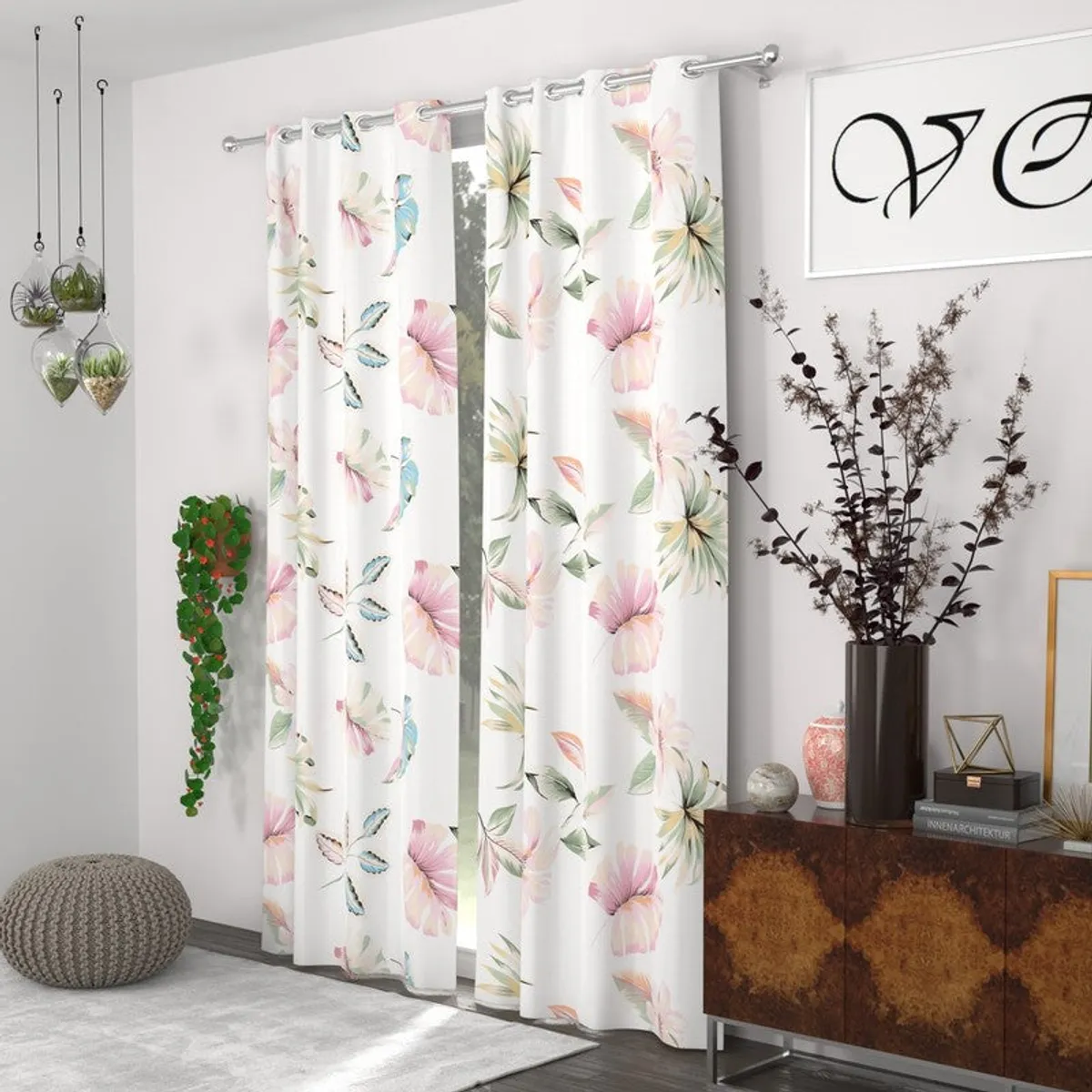 Pair of white botanical-print curtains framing a window in a bright living room.