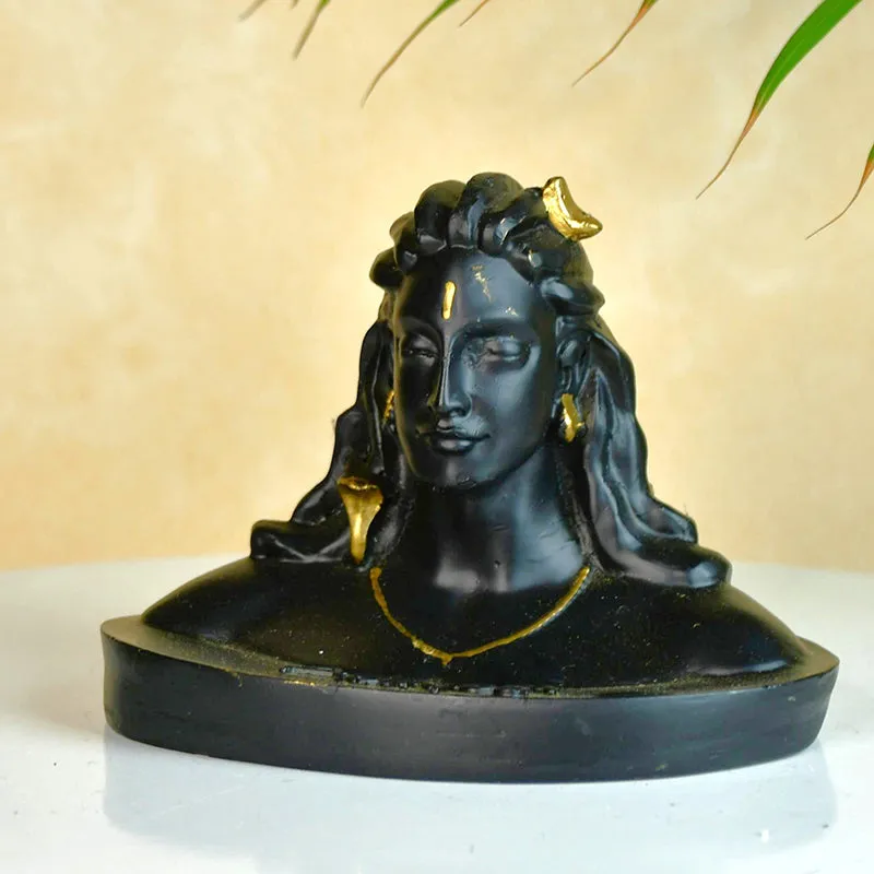 Front view of the black Adiyogi showpiece against a warm beige backdrop