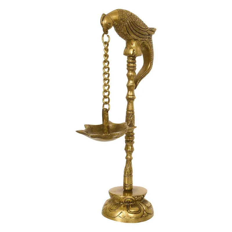 Gold parrot-shaped brass diya shown from the front against a white background.