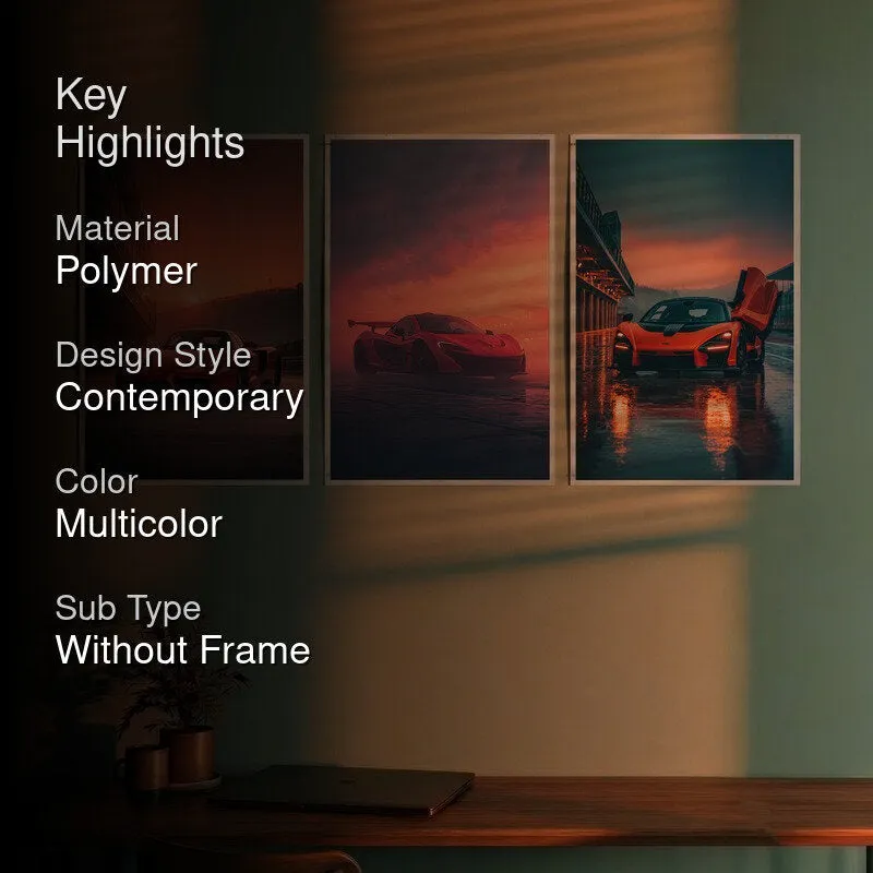 Three car posters displayed on a wall in a room setting