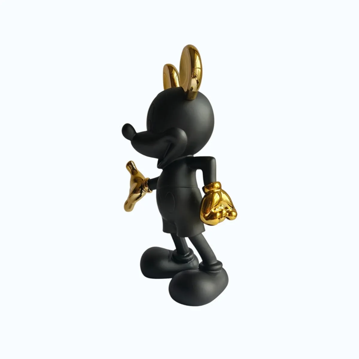 Angled side view of the black and gold character-inspired figurine