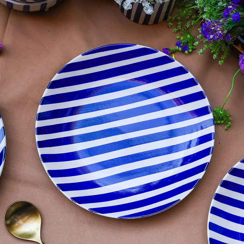 Round blue and white striped quarter plate on a table setting