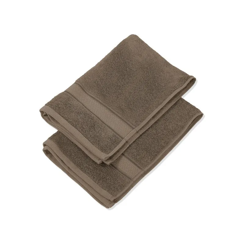 Folded grey towels stacked on a white background