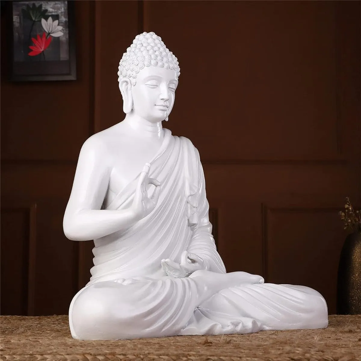 Side view showing the sculpted profile of a white meditating Buddha idol