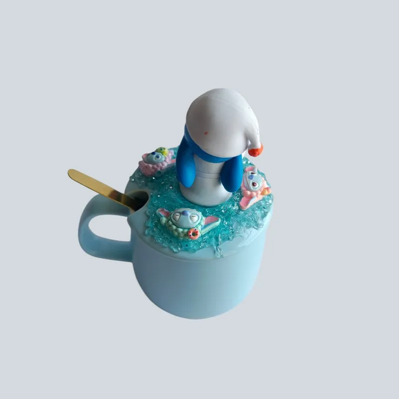 Blue mug with decorative Stitch figurine lid and spoon