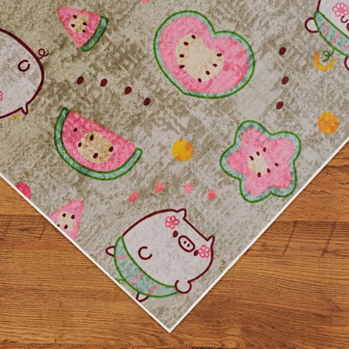Corner view of beige rectangular carpet with pink and green printed design