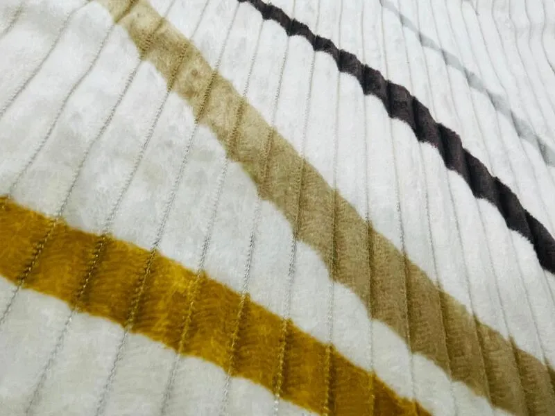 Close-up of the flannel fabric with diagonal wave stripes on a ribbed white surface