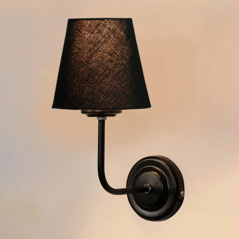 Front view of black wall lamp with round iron base and black shade