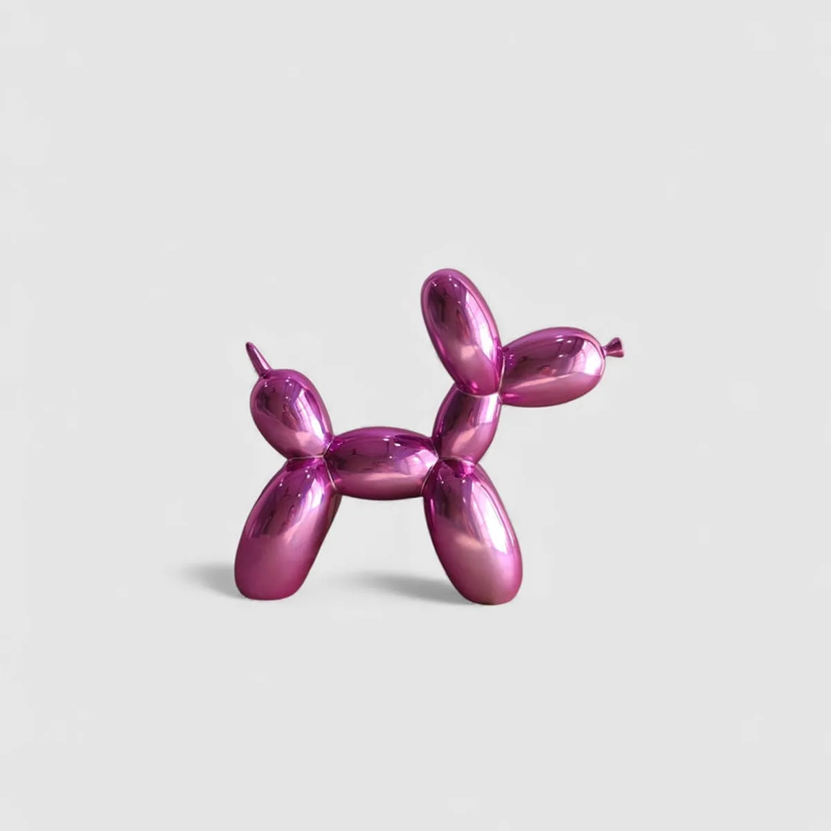 Profile view of a pink balloon dog showpiece on a plain light background.