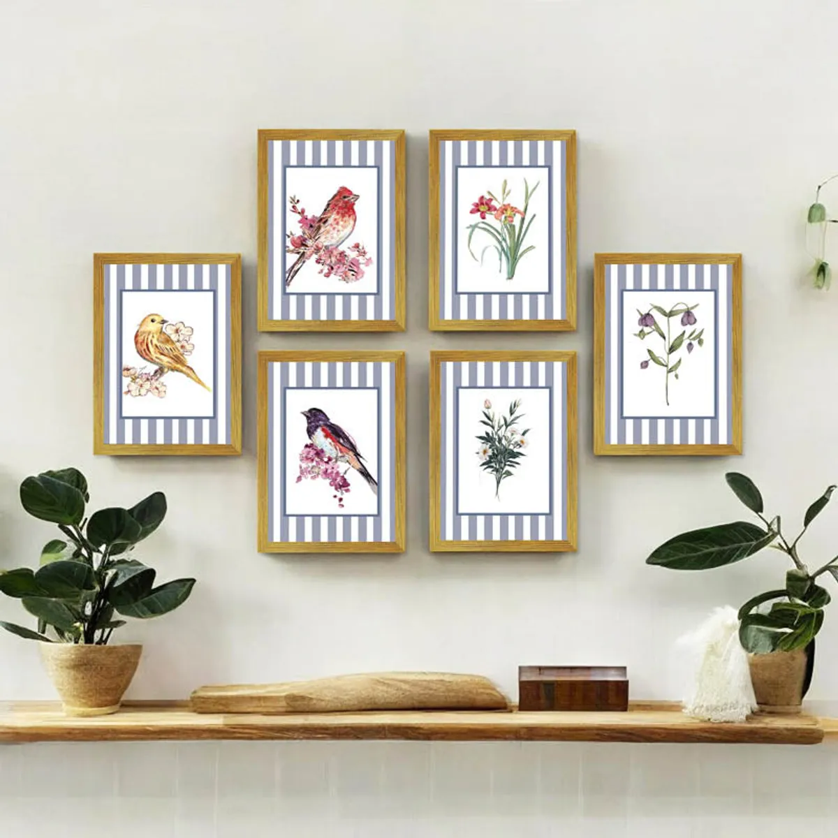 Six brown framed floral and bird prints arranged above a wooden console with potted plants.