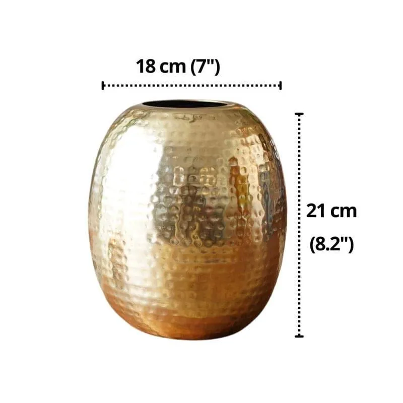 Gold hammered oval vase on a white background