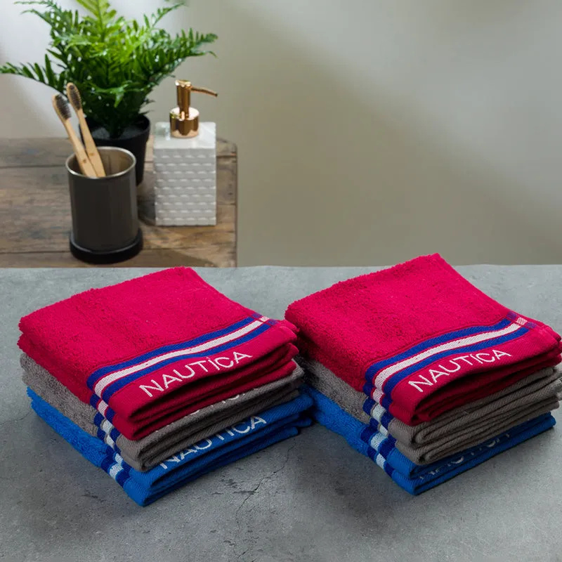 Two stacks of colourful striped Nautica face towels styled on a bathroom counter