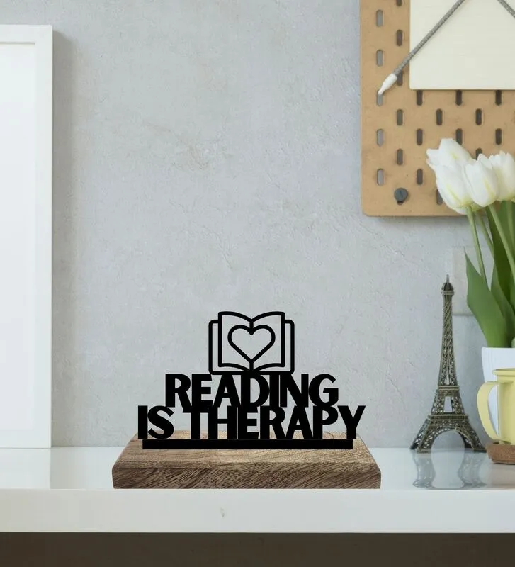 Reading is Therapy typography showpiece on a wooden base on a shelf