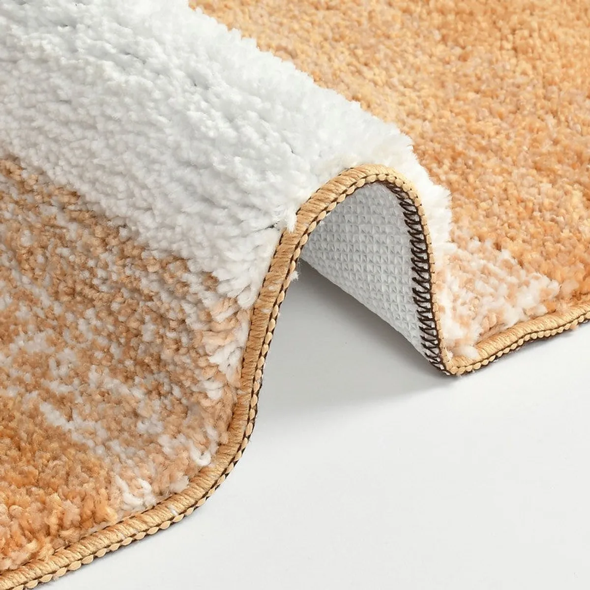 Close-up of the bath mat's textured surface and finished edge