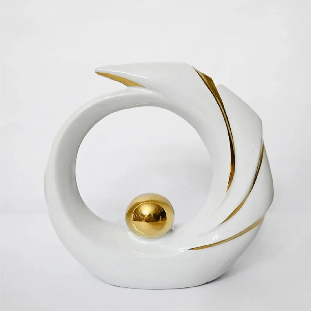 White and gold sculptural tabletop showpiece on a plain white background